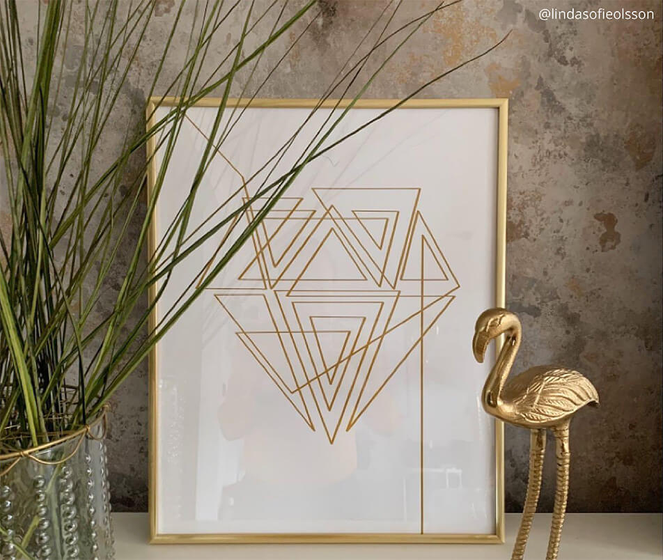 Golden picture frame on a stone wall - decoration details in gold