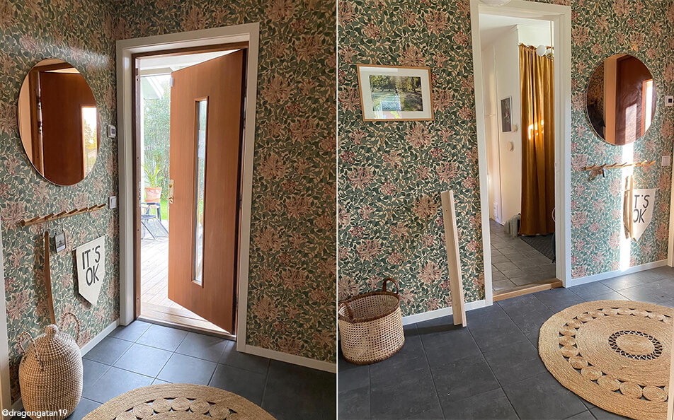 Flowery wallpaper in hall, round mirror with toned glass