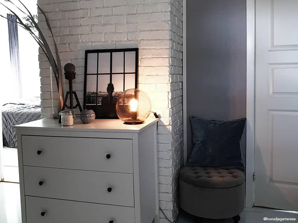 Hall decoration - white chest of drawers against white brick wall