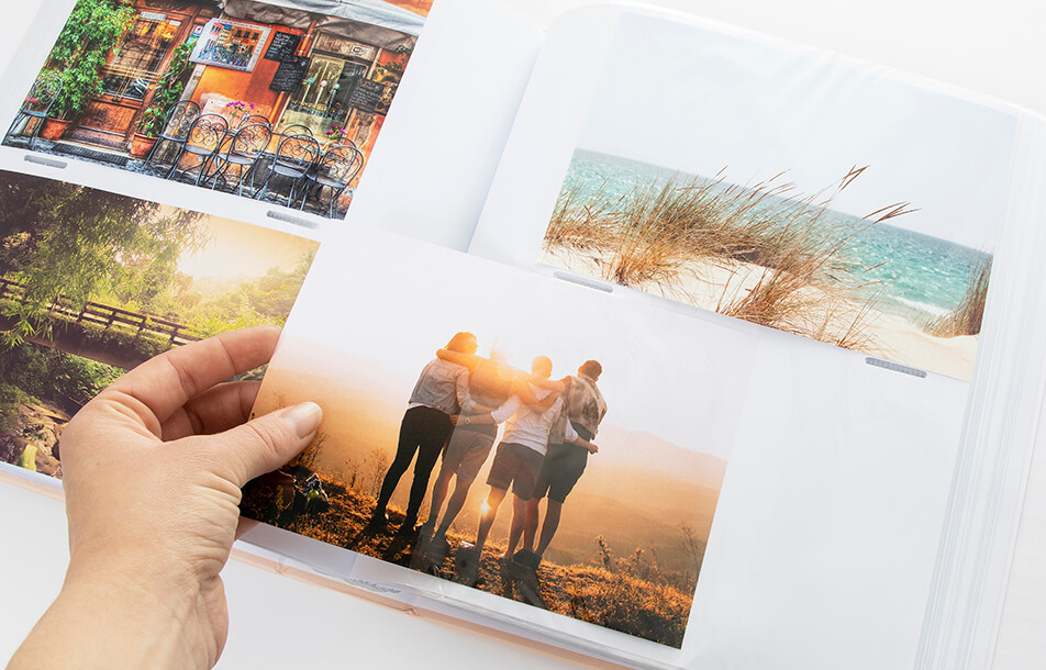 Open photo album with plastic sleeves and photos
