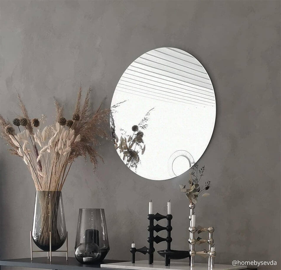 Round mirror on a grey wall